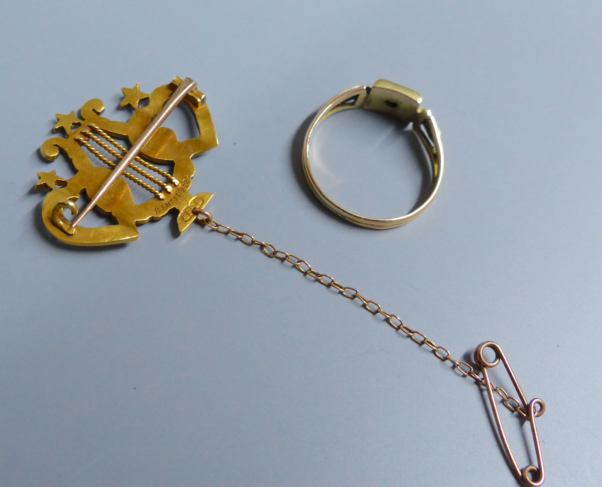 An Edwardian 18ct, turquoise and seed pearl set twin hearts with lyre brooch, 28mm, gross 4.2 grams & a ring.